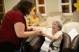 An elderly person assisted by one of the caregivers