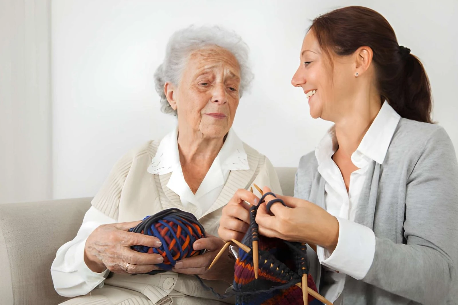 old women teaching how to stitch