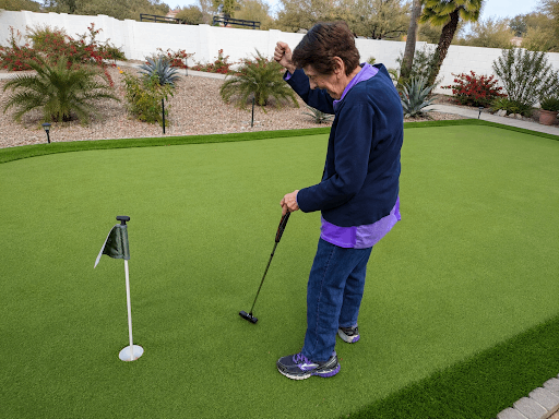 An elderly person enjoying a game of golf