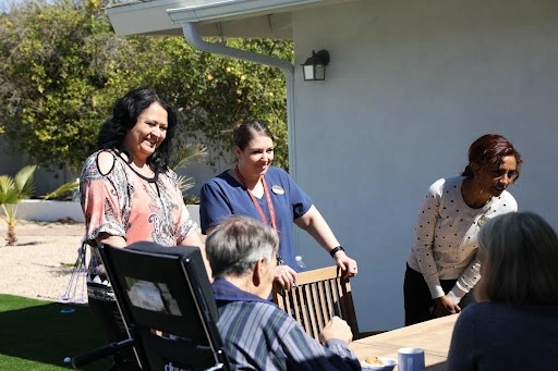 Caregivers and visitors spend time with the elderly