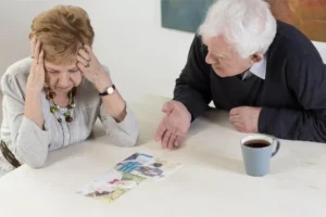 Distressed elderly woman discussing family photos