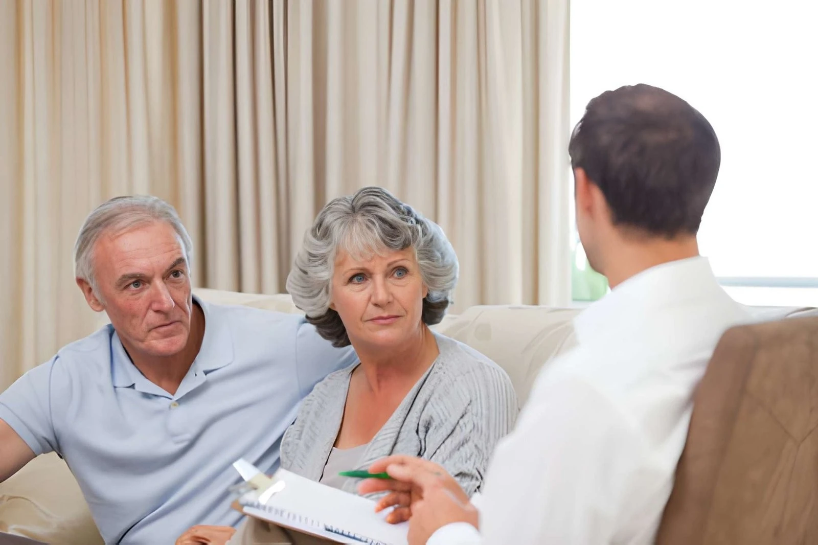 Older couple discussing dementia care with a healthcare professional