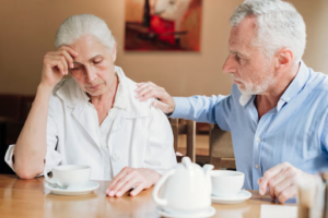 Older man comforting a worried woman